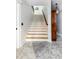 Stylish staircase with beautiful wood steps, shiplap accent wall, and neutral marble-look flooring at 1391 Royston Rd, Mount Pleasant, SC 29464