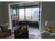 Bright sun room with chairs and a view of the city through a large window at 14 Lockwood Dr # 6I, Charleston, SC 29401