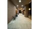 Long walkway with brick walls and overhead lighting leads to a common outdoor area at 14 Lockwood Dr # 6I, Charleston, SC 29401