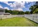 Spacious backyard features a well-maintained lawn enclosed by a classic white picket fence, offering privacy at 1418 Whispering Oak Trl, Mount Pleasant, SC 29466