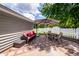 Inviting backyard patio setup with stylish furniture, a charming picket fence, and lush green trees at 1418 Whispering Oak Trl, Mount Pleasant, SC 29466