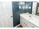 Bathroom vanity with white sink, faucet and mirror complemented by a dark blue accent wall and modern fixtures at 1418 Whispering Oak Trl, Mount Pleasant, SC 29466