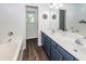 Bright bathroom with double sinks, modern vanity, and a soaking tub, providing a functional and stylish space at 1418 Whispering Oak Trl, Mount Pleasant, SC 29466