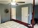 Gray bedroom features a ceiling fan, two doors, and a dark wood four-poster bed at 1418 Whispering Oak Trl, Mount Pleasant, SC 29466