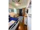 Bright bedroom with blue rug, wooden floors, and barn door entrance at 1418 Whispering Oak Trl, Mount Pleasant, SC 29466
