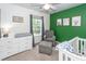 Cozy Bedroom with crib, dresser, chair, and a bright accent wall decorated with cute animal pictures at 1418 Whispering Oak Trl, Mount Pleasant, SC 29466