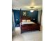 Spacious bedroom features a four-poster bed, ceiling fan, and accent wall at 1418 Whispering Oak Trl, Mount Pleasant, SC 29466