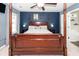 Spacious bedroom features a four-poster bed, ceiling fan, and ample natural light from the window at 1418 Whispering Oak Trl, Mount Pleasant, SC 29466
