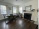 Cozy dining room featuring a fireplace, stylish furniture, and natural light from large windows at 1418 Whispering Oak Trl, Mount Pleasant, SC 29466