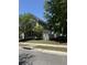 Charming two-story home featuring gray siding, black shutters, and a white picket fence at 1418 Whispering Oak Trl, Mount Pleasant, SC 29466
