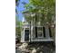 Inviting two-story home with front porch, showcasing curb appeal and manicured landscaping at 1418 Whispering Oak Trl, Mount Pleasant, SC 29466