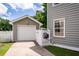 Exterior view of the home featuring a detached garage and a well-maintained side yard at 1418 Whispering Oak Trl, Mount Pleasant, SC 29466