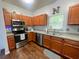 Functional kitchen equipped with stainless steel appliances, warm cabinets, and ample counter space at 1418 Whispering Oak Trl, Mount Pleasant, SC 29466
