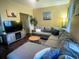 Inviting living room with sectional sofa, wooden table, and decorative artwork at 1418 Whispering Oak Trl, Mount Pleasant, SC 29466