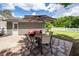 Relaxing patio with a dining table, comfortable seating, and umbrella providing shade on a sunny day at 1418 Whispering Oak Trl, Mount Pleasant, SC 29466