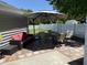 Outdoor patio featuring brick pavers, comfortable seating under an umbrella, and a well-maintained backyard with white fence at 1418 Whispering Oak Trl, Mount Pleasant, SC 29466