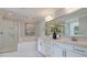 Luxurious bathroom featuring a soaking tub, glass-enclosed shower, and dual vanity sinks at 142 Seaton St, Summerville, SC 29486