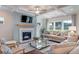 Cozy living room featuring a fireplace, coffered ceiling, large windows, and comfortable seating at 142 Seaton St, Summerville, SC 29486