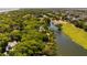 Overhead view of homes surrounded by trees along a lagoon and golf course near the beach, providing an idyllic setting at 15 Edgewater Aly, Isle of Palms, SC 29451