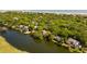 Stunning aerial view of waterfront homes nestled among lush trees, offering privacy and beautiful scenery near the beach at 15 Edgewater Aly, Isle of Palms, SC 29451