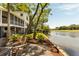 Waterfront backyard featuring a patio area with outdoor seating and an outdoor bar near the water at 15 Edgewater Aly, Isle of Palms, SC 29451
