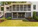 Charming backyard with outdoor bar, patio, and screened porch, seamlessly blending indoor and outdoor living at 15 Edgewater Aly, Isle of Palms, SC 29451