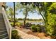 Scenic backyard with a paver patio, Adirondack chairs, and serene water views at 15 Edgewater Aly, Isle of Palms, SC 29451