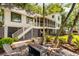 Landscaped backyard features a fire pit with Adirondack chairs, perfect for enjoying cool evenings at 15 Edgewater Aly, Isle of Palms, SC 29451