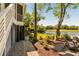 Lakeside backyard view showcasing lush greenery, Adirondack chairs, and a tranquil setting at 15 Edgewater Aly, Isle of Palms, SC 29451