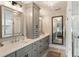 Spacious bathroom featuring double sinks, a decorative mirror, and a walk-in shower at 15 Edgewater Aly, Isle of Palms, SC 29451