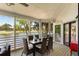 Screened-in dining area with a table for eight and waterfront view overlooking the golf course at 15 Edgewater Aly, Isle of Palms, SC 29451