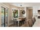 Cozy dining area with a wooden table, decorative chandelier, and views of the lake at 15 Edgewater Aly, Isle of Palms, SC 29451