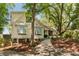 Inviting two-story home with classic architecture, well-manicured landscaping and a welcoming walkway leading to the front door at 15 Edgewater Aly, Isle of Palms, SC 29451