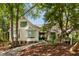 Charming two-story home with a beautifully landscaped front yard and mature trees for added privacy at 15 Edgewater Aly, Isle of Palms, SC 29451