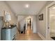 Inviting hallway with wood floors and beach-themed decor leading to stairs and a bathroom at 15 Edgewater Aly, Isle of Palms, SC 29451