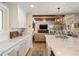 Bright kitchen and living room area, with long countertops, wood beams and recessed lighting at 15 Edgewater Aly, Isle of Palms, SC 29451