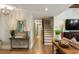 Stylish hall with decor, wood floors, a staircase, and a decorative light fixture at 15 Edgewater Aly, Isle of Palms, SC 29451