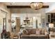 Open-concept living room and kitchen with hardwood floors, a modern kitchen, and a decorative chandelier at 15 Edgewater Aly, Isle of Palms, SC 29451