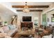 Comfortable living room with wooden beams, a decorative chandelier, and a view to the Primary bedroom at 15 Edgewater Aly, Isle of Palms, SC 29451