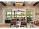Relaxing living room with golf course views and access to an outdoor screened-in patio area at 15 Edgewater Aly, Isle of Palms, SC 29451