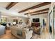 Large living room featuring hardwood floors, exposed beams, comfortable seating, and a large-screen TV at 15 Edgewater Aly, Isle of Palms, SC 29451