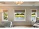Main bedroom with views of the lake and golf course, accented by a decorative chandelier at 15 Edgewater Aly, Isle of Palms, SC 29451