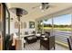 Screened-in porch featuring comfortable seating, a ceiling fan, and a scenic view of the lake and golf course at 15 Edgewater Aly, Isle of Palms, SC 29451