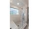 Modern walk-in shower with glass walls, a built-in bench, and a decorative shower head at 15 Edgewater Aly, Isle of Palms, SC 29451