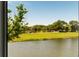 Scenic view from a window overlooking a pond and lush golf course at 15 Edgewater Aly, Isle of Palms, SC 29451