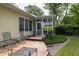 Exterior view showcasing the deck and screened porch, with lush landscaping, enhancing the home's outdoor appeal at 1578 Harborsun Dr, Charleston, SC 29412