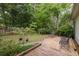 Spacious backyard features a wooden deck, mature trees, and lush greenery, creating a peaceful outdoor retreat at 1578 Harborsun Dr, Charleston, SC 29412