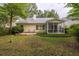 Exterior view of the home with a deck and screened-in porch overlooking the lush, well-maintained backyard at 1578 Harborsun Dr, Charleston, SC 29412