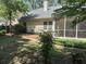 Backyard featuring a screened-in porch and a small deck area surrounded by trees and greenery at 1578 Harborsun Dr, Charleston, SC 29412