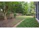 Picturesque backyard with mature trees, well-maintained lawn, and charming landscaping, creating a tranquil outdoor oasis at 1578 Harborsun Dr, Charleston, SC 29412